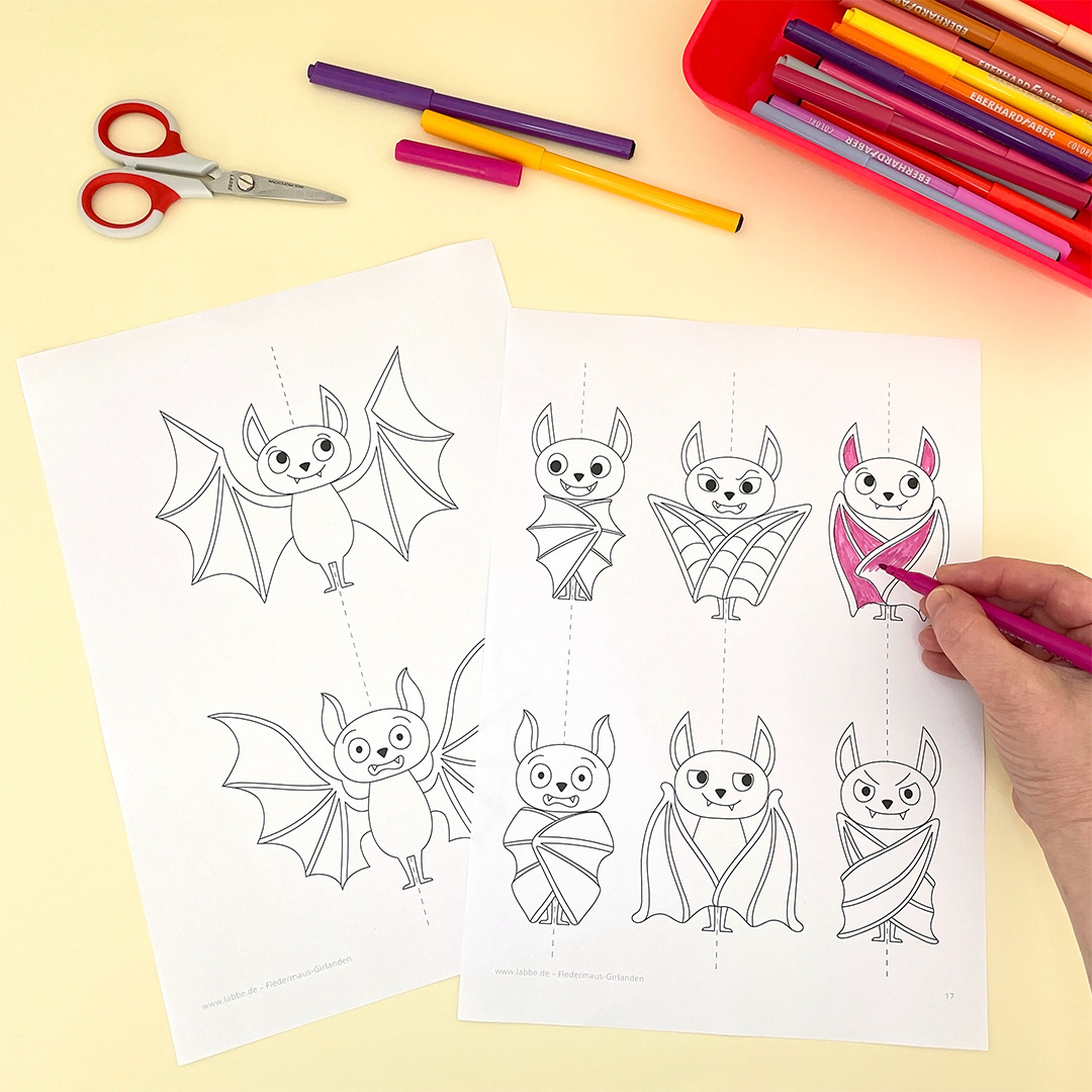 Ausgedruckte Fledermaus-Vorlagen werden mit Filzstiften ausgemalt